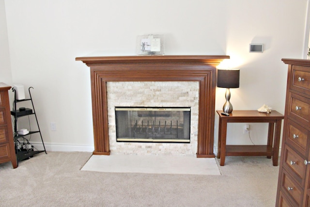 detailed view of carpet flooring, a fireplace with flush hearth, and baseboards