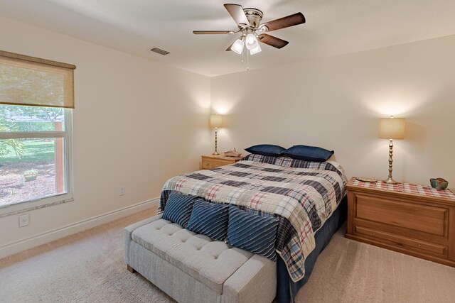 8005 SW Yachtsmans Dr, Stuart, FL 34997 - bedroom with light carpet, baseboards, and ceiling fan