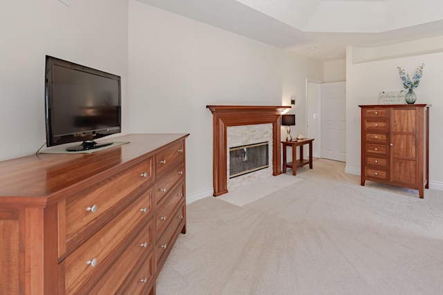 8005 SW Yachtsmans Dr, Stuart, FL 34997 - bedroom featuring a tiled fireplace, light colored carpet, and baseboards