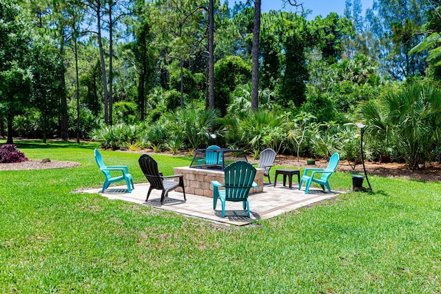 8005 SW Yachtsmans Dr, Stuart, FL 34997 - view of grassy yard featuring an outdoor fire pit and a patio