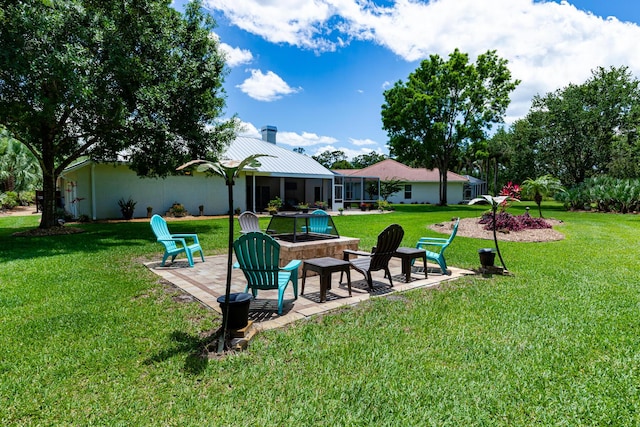 8005 SW Yachtsmans Dr, Stuart, FL 34997 - view of green lawn featuring an outdoor fire pit and a patio area