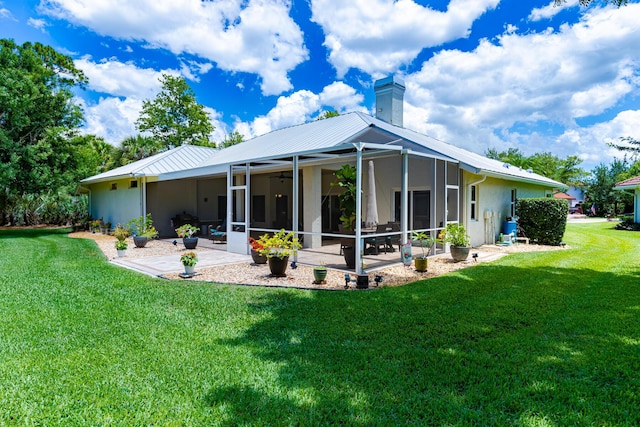 8005 SW Yachtsmans Dr, Stuart, FL 34997 - rear view of house with a ceiling fan, a yard, a chimney, a patio area, and a sunroom