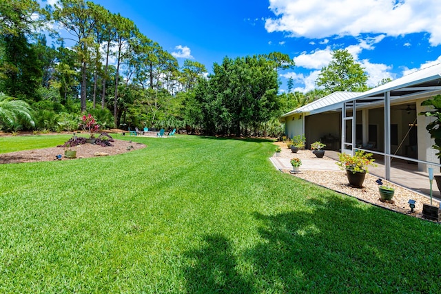 8005 SW Yachtsmans Dr, Stuart, FL 34997 - view of grassy yard featuring a patio area and ceiling fan