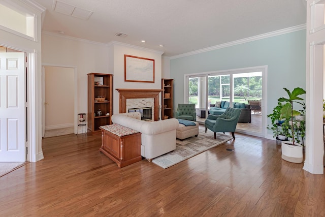 8005 SW Yachtsmans Dr, Stuart, FL 34997 - living area featuring light wood-type flooring, a glass covered fireplace, crown molding, and baseboards