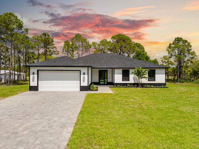 17816 86th St N, The Acreage, FL 33470 - view of front of house featuring decorative driveway, a garage, and a front yard