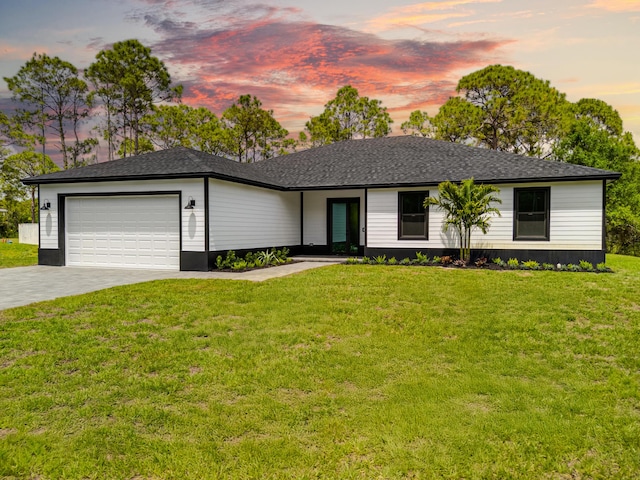 17816 86th St N, The Acreage, FL 33470 - ranch-style home featuring a lawn, driveway, roof with shingles, and a garage