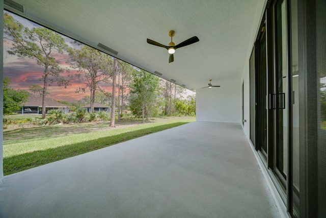 17816 86th St N, The Acreage, FL 33470 - patio terrace at dusk featuring ceiling fan and a yard