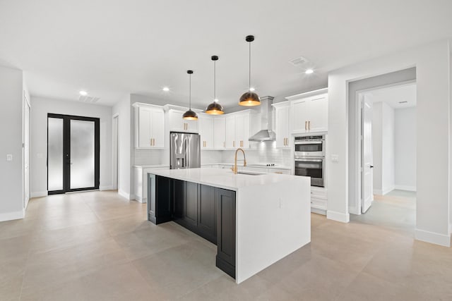 17816 86th St N, The Acreage, FL 33470 - kitchen with wall chimney range hood, a sink, light countertops, stainless steel appliances, and white cabinetry