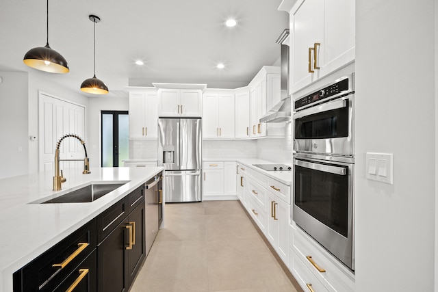 17816 86th St N, The Acreage, FL 33470 - kitchen featuring white cabinets, dark cabinets, a sink, backsplash, and stainless steel appliances