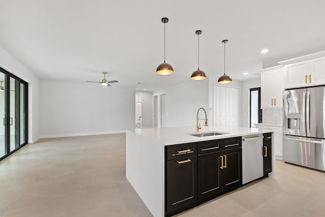 17816 86th St N, The Acreage, FL 33470 - kitchen featuring appliances with stainless steel finishes, a sink, light countertops, dark cabinets, and white cabinetry