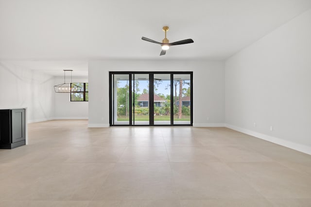 17816 86th St N, The Acreage, FL 33470 - empty room featuring baseboards and ceiling fan with notable chandelier