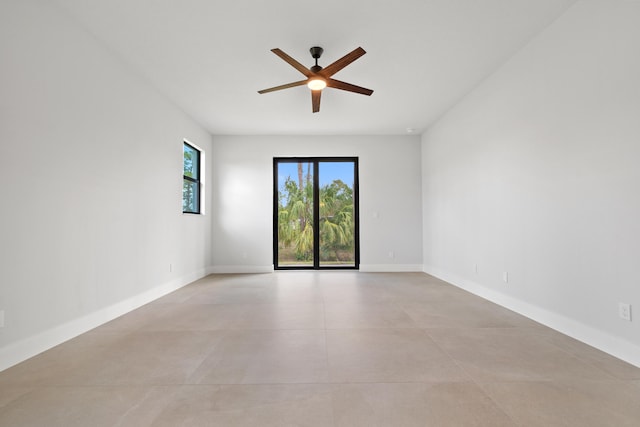 17816 86th St N, The Acreage, FL 33470 - empty room featuring finished concrete floors, a ceiling fan, and baseboards