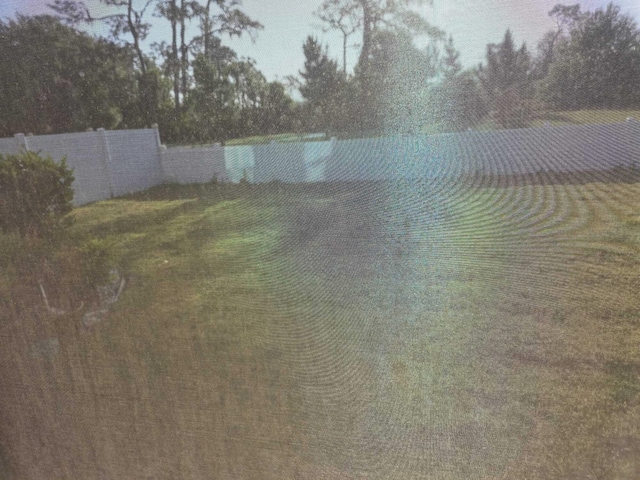 property view of water featuring fence