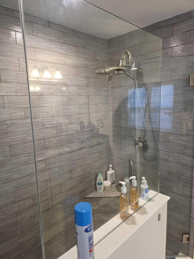 bathroom with tiled shower