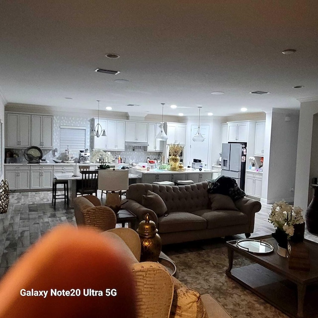 living area featuring recessed lighting and visible vents