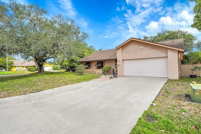 ranch-style house featuring a garage, a front lawn, fence, stucco siding, and concrete driveway
