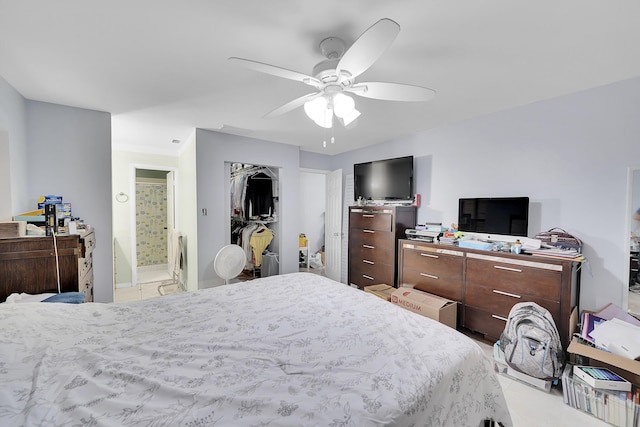 bedroom with baseboards, ceiling fan, and ensuite bathroom