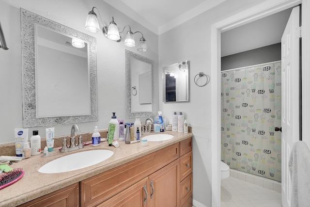 full bath featuring double vanity, a sink, a stall shower, and toilet