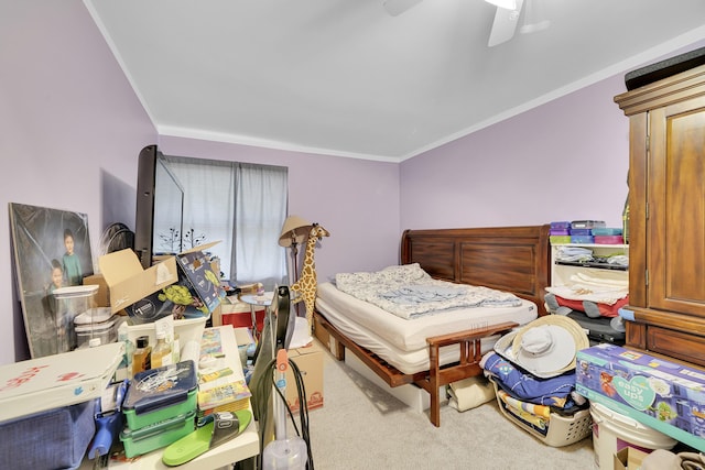 carpeted bedroom with a ceiling fan and ornamental molding