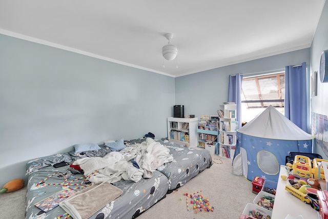 bedroom with crown molding, a ceiling fan, and carpet