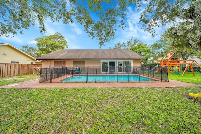 view of pool featuring a fenced in pool, fence, a yard, and a playground