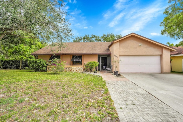 ranch-style house with concrete driveway, an attached garage, a front yard, and stucco siding