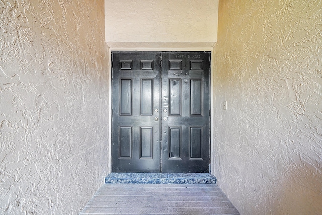 doorway to property with stucco siding