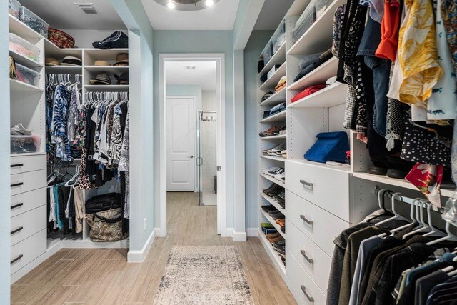 1220 Haywagon Trl, The Acreage, FL 33470 - spacious closet featuring light wood-type flooring and visible vents