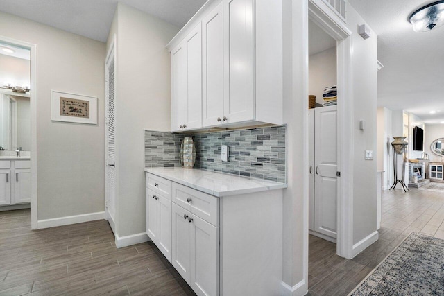 1220 Haywagon Trl, The Acreage, FL 33470 - corridor featuring a sink, baseboards, visible vents, and wood finished floors