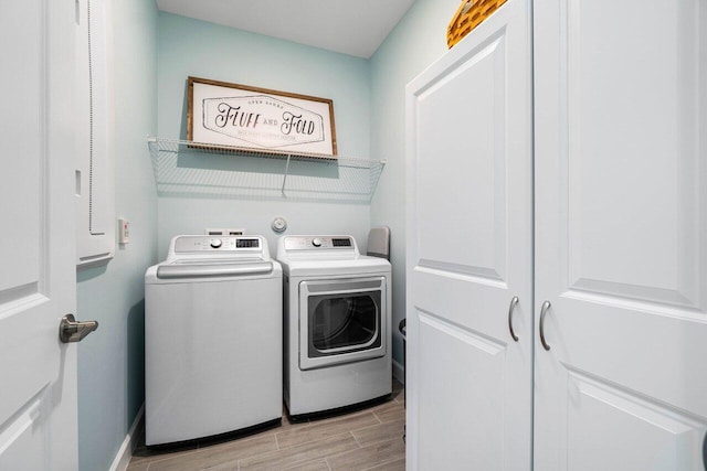 1220 Haywagon Trl, The Acreage, FL 33470 - clothes washing area featuring baseboards, wood finish floors, laundry area, and washer and dryer