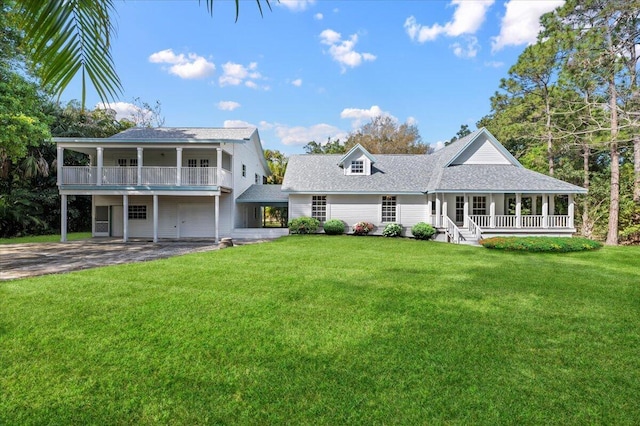 17647 N 112th Dr N, Jupiter, FL 33478 - rear view of property featuring a porch, roof with shingles, driveway, and a lawn