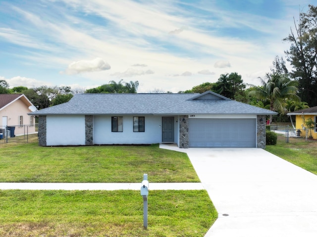 185 Bilbao St, Royal Palm Beach, FL 33411 - ranch-style home with an attached garage, fence, stone siding, and a front lawn