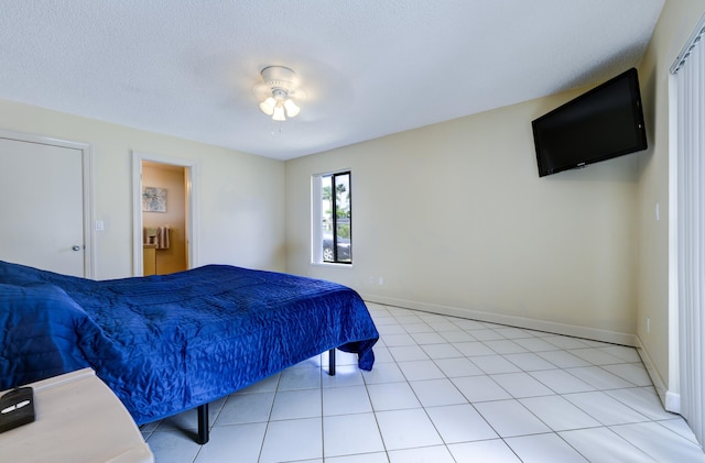 185 Bilbao St, Royal Palm Beach, FL 33411 - bedroom featuring light tile patterned floors, baseboards, and a textured ceiling