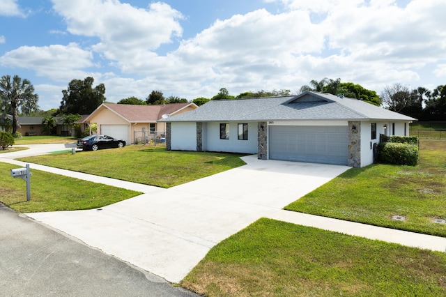 185 Bilbao St, Royal Palm Beach, FL 33411 - ranch-style home featuring fence, an attached garage, a front lawn, stone siding, and concrete driveway