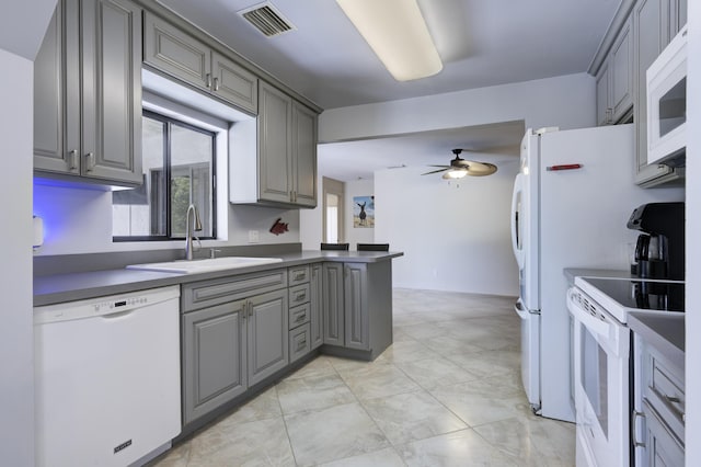 185 Bilbao St, Royal Palm Beach, FL 33411 - kitchen with ceiling fan, visible vents, a sink, gray cabinetry, and white appliances
