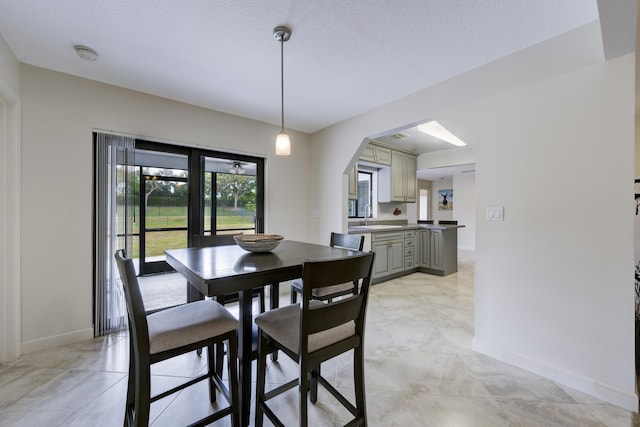 185 Bilbao St, Royal Palm Beach, FL 33411 - dining space with baseboards and arched walkways
