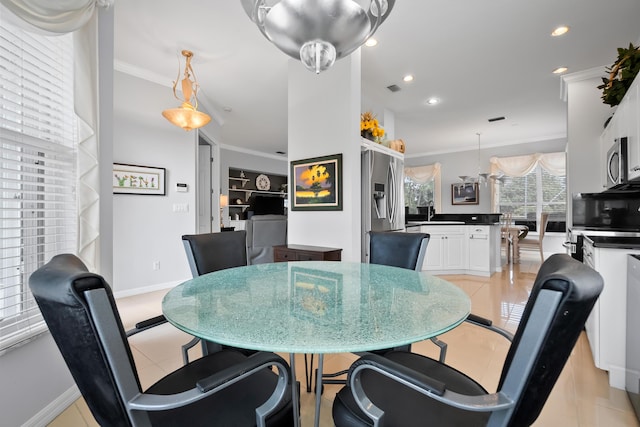 dining space with crown molding, recessed lighting, and baseboards