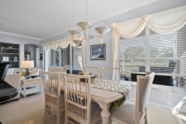 tiled dining space with crown molding and arched walkways