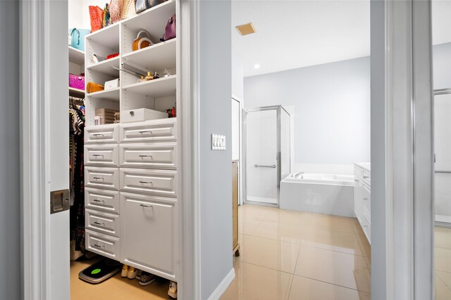 full bath with a stall shower, a bath, vanity, and tile patterned floors