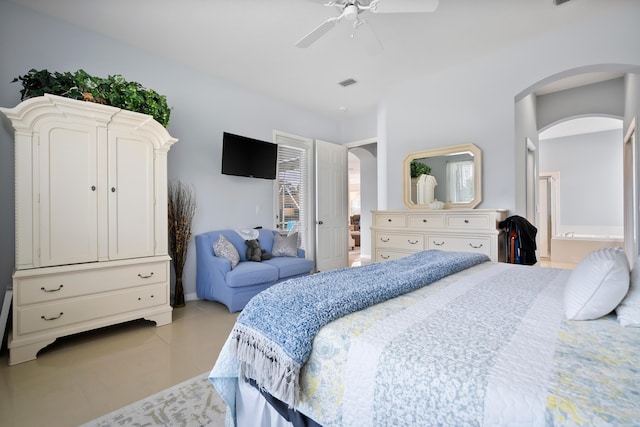 2232 SW Brookhaven Way, Palm City, FL 34990 - bedroom with arched walkways, light tile patterned flooring, and a ceiling fan