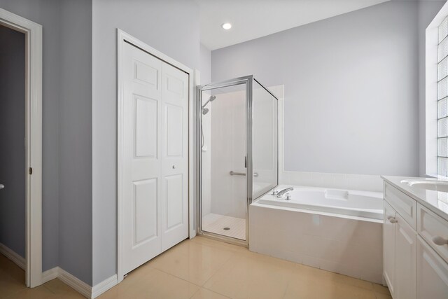 ensuite bathroom with double vanity and tile patterned flooring