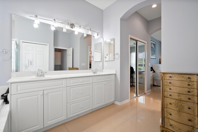 full bathroom featuring a bath, a stall shower, vanity, and tile patterned flooring