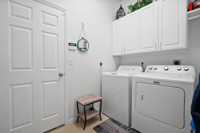 2232 SW Brookhaven Way, Palm City, FL 34990 - laundry area with cabinet space, washing machine and dryer, and baseboards