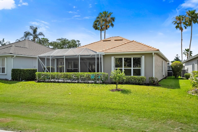2232 SW Brookhaven Way, Palm City, FL 34990 - rear view of property with a tile roof, stucco siding, a lawn, and a lanai