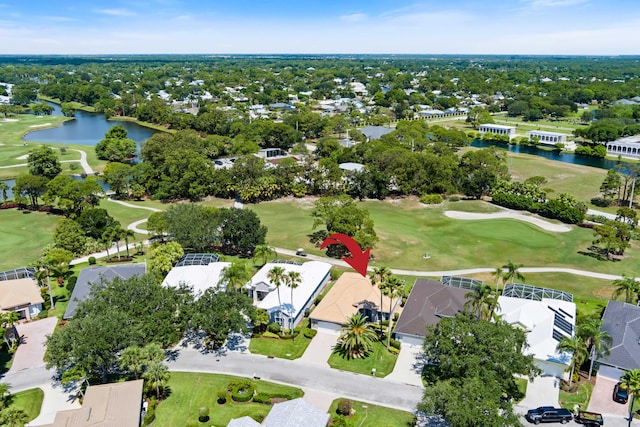 aerial perspective of suburban area featuring a golf club and a nearby body of water