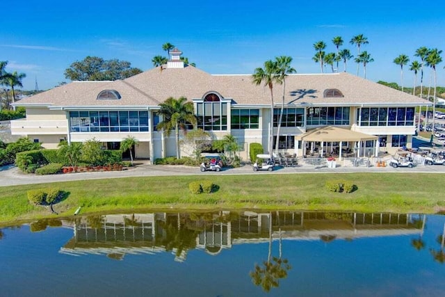 rear view of property featuring a water view and a chimney