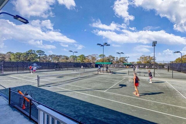 view of tennis court featuring fence