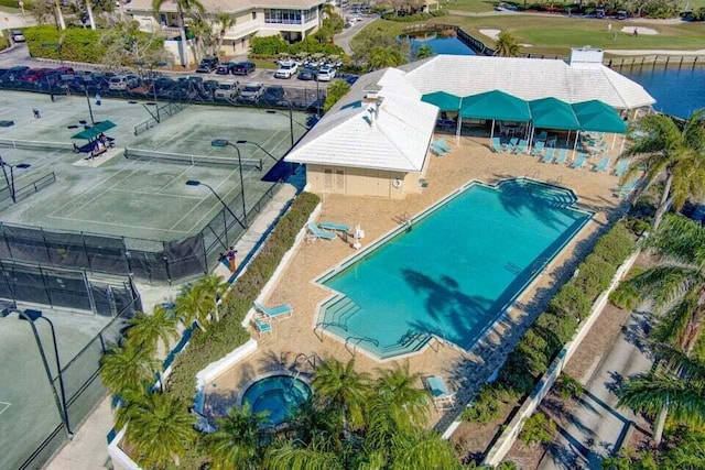 aerial view of a pool area and a nearby body of water
