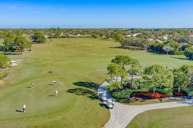 bird's eye view of a golf course and a tree filled landscape