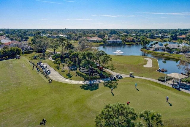 bird's eye view of a nearby body of water, a golf club, and a tree filled landscape